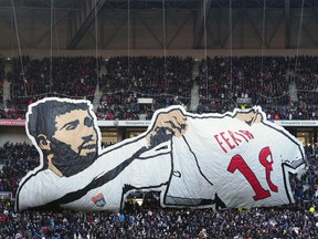 Lyon supporters wave a flag depicting Lyon's player Nabil Fekir during their French League One soccer match against Saint-Etienne, in Decines, near Lyon, central France, Sunday, Feb. 25, 2018.