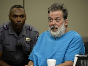 FILE - In this Dec. 9, 2015 file photo, Robert Lewis Dear talks to Judge Gilbert Martinez during a court appearance in Colorado Springs, Colo. A Colorado judge says Dear, who acknowledges killing three people at a Planned Parenthood clinic remains mentally incompetent. The hearing Tuesday, Feb. 13, 2018, was the first review of Robert Dear's mental health since the Colorado Court of Appeals in January upheld a lower court's ruling that he can be medicated against his will.