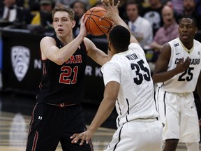 Utah forward Tyler Rawson, left, looks to pass the ball as Colorado forward Dallas Walton defends during the first half of an NCAA college basketball game Friday, Feb. 2, 2018, in Boulder, Colo.