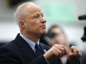 U.S. Rep. Mike Coffman, R-Colorado, talks during a news conference before a town hall meeting with constituents in a high school assembly hall Tuesday, Feb. 20, 2018, in Greenwood Village, Colo. Coffman was peppered with questions about gun control in the wake of the mass shooting in south Florida last week.