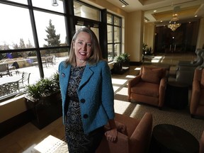 In this Friday, Feb. 16, 2018, photo, Lisa A. Goodbee, president Goodbee Associates, poses for a photo in the lobby of the building where the civil engineering firm is located in the Denver south suburb of Greenwood Village, Colo. Goodbee gives the 17 staffers at her civil engineering firm six weeks at full pay and 12 at half pay for parental or caregiving leave.