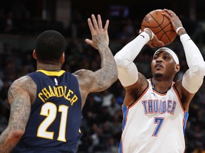 Oklahoma City Thunder forward Carmelo Anthony shoots as Denver Nuggets forward Wilson Chandler defends during the first half of an NBA basketball game Thursday, Feb. 1, 2018, in Denver.