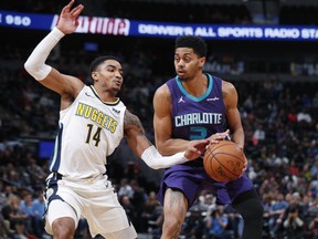 Denver Nuggets guard Gary Harris, left, defends as Charlotte Hornets guard Jeremy Lamb drives the lane to the rim in the first half of an NBA basketball game Monday, Feb. 5, 2018, in Denver.