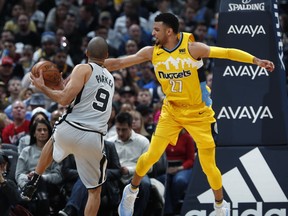 Denver Nuggets guard Jamal Murray, right, defends as San Antonio Spurs guard Tony Parker drives to the basket during the first half of an NBA basketball game Friday, Feb. 23, 2018, in Denver.