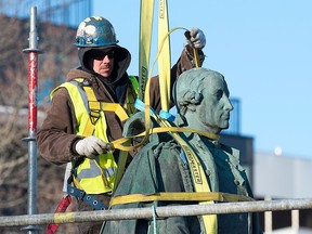 Contractors remove a statue of Edward Cornwallis from a Halifax park on Wednesday, Jan. 31, 2018.