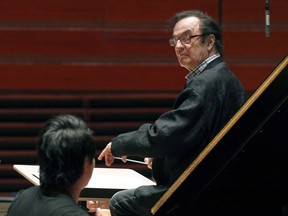 World-renowned conductor Charles Dutoit, right, performs with the Philadelphia Orchestra during a rehearsal in Philadelphia on October 19, 2011. The chair of the board of directors for the Montreal Symphony Orchestra is expressing his sympathy to those who have spoken up about alleged psychological harassment and intimidation by its former artistic director. Several musicians have told Montreal media outlets La Presse and Le Devoir that Charles Dutoit would repeatedly insult, humiliate and verbally lash out at musicians when he was the orchestra's artistic director from 1977 to 2002. Lucien Bouchard, who in addition to his role with the orchestra is also a former premier of Quebec, says in a statement that the testimonies will strengthen the orchestra's determination to provide a harmonious working environment.