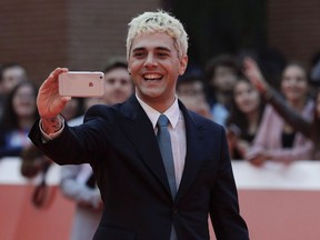 Quebec filmmaker Xavier Dolan says he has cut actress Jessica Chastain from his upcoming movie "The Death and Life of John F. Donovan." Actor and director Xavier Dolan poses for photos on the red carpet of the 12th edition of the Rome Film Fest, in Rome, Friday, Oct. 27, 2017.