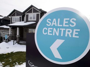 Mortgage brokers say the borrower rejection rate from large banks and traditional monoline mortgage lenders has gone up as much as 20 per cent after Canada's banking regulator imposed a new stress test for home buyers who don't need mortgage insurance. A sales centre sign is shown outside a house under construction in a new subdivision in Beckwith, Ont., on Wednesday, Jan. 11, 2018.