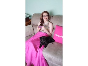 Rebecca Schofield sits with her dog in a June 20, 2017, family handout photo. Schofield, a New Brunswick teenager who turned a terminal prognosis into an online campaign for kindness, has died of brain cancer.