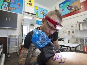 Toby Sicks of Inkdigenous Tattoo inks a native eagle in Toronto on Thursday February 1, 2018. Believing a centuries-old Indigenous tradition had been all but erased, Interior Salish tattoo artist Dion Kaszas decided to use his body to resurrect the ways of his ancestors, with a needle and ink. THE CANADIAN PRESS/Frank Gunn