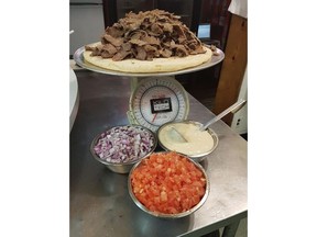 A six-pound donair is shown at Alexandra's Pizza in Sydney, N.S., on Wednesday, Feb. 21, 2018. It's six pounds of roasted meat, tomatoes and sweet garlic sauce atop a pizza-sized pita -- and so far no one has conquered eating the enormous donair. Alexandra's Pizza in Sydney, N.S., has been challenging people to devour its massive version of the East Coast delicacy, but after 17 attempts in the last five months, they've yet to crown a champion.