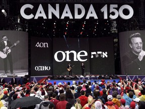 U2's Bono, right, and The Edge perform on stage during the Canada Day noon hour show on Parliament Hill in Ottawa on July 1, 2017. Statistics Canada says international tourism set an annual record during Canada 150 last year, with 20.8 million trips of one or more nights, although visits from the United States were down.THE CANADIAN PRESS/Justin Tang