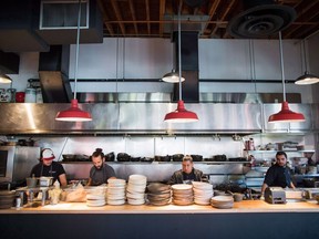 Kitchen staff prepare for dinner service at Edible Canada restaurant in Vancouver, B.C., on Wednesday October 11, 2017.