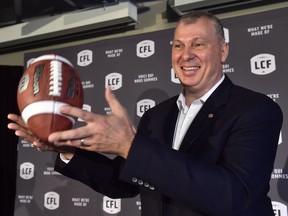 Randy Ambrosie tosses a football as he speaks during a press conference in Toronto on July 5, 2017. The Canadian Football League's commissioner will be in Halifax Friday, for what's expected to be a morale booster to those hoping the city will gain a professional team. Randy Ambrosie issued a news release noting the league has made the Nova Scotia capital the sole non-franchise city on his national tour.