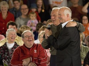 Former NDP British Columbia Premier Dave Barrett, centre, gets up to greet NDP Leader Jack Layton at a town hall meeting Thursday Sept. 25, 2008 in Victoria. Former British Columbia premier Dave Barrett has died at the age of 87. A statement from Premier John Horgan's office says the former NDP premier died after a long struggle with Alzheimer's disease.THE CANADIAN PRESS/Jacques Boissinot