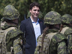 Canadian Prime Minister Justin Trudeau reviews an honour guard as they arrive at the International Peacekeeping and Security Centre in Yavoriv, Ukraine Tuesday July 12, 2016.