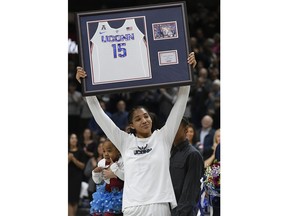Connecticut's Gabby Williams holds up a jersey with her number a Senior Night Ceremony before an NCAA college basketball game against South Florida, Monday, Feb. 26, 2018, in Storrs, Conn.