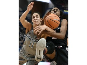 Connecticut's Kia Nurse, left, fights for a rebound with Temple's Breanna Perry during the first half an NCAA college basketball game Sunday, Feb. 18, 2018, in Hartford, Conn.