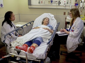 Nurses Lisa Lui-Popelka, left, and Emily Ruben, right, talk with Northwestern Memorial Hospital patient Carol Wittwer at her bedside in a special wing of the Emergency Department in Chicago on Jan. 10, 2018. Popelka and Ruben are specially trained to treat older patients and, when possible, arrange help for them at home. That prevents unneeded hospital admissions and a host of potential problems that can make older patients sicker.