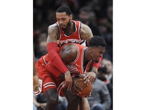 Chicago Bulls' Bobby Portis front, battles Washington Wizards' Mike Scott back, for a loose ball during the first half of an NBA basketball game Saturday, Feb. 10, 2018, in Chicago.