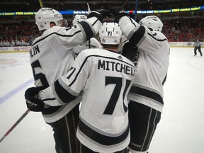 Los Angeles Kings center Torrey Mitchell (71) celebrates with teammate after scoring a goal against the Chicago Blackhawks during the first period of an NHL hockey game Monday, Feb. 19, 2018, in Chicago.