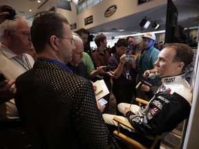 Kevin Harvick, right, talks with reporters during media day for the NASCAR Daytona 500 auto race at Daytona International Speedway, Wednesday, Feb. 14, 2018, in Daytona Beach, Fla.