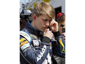 William Byron adjusts his ear plugs before getting in his car during  NASCAR auto racing practice at Daytona International Speedway, Saturday, Feb. 10, 2018, in Daytona Beach, Fla.