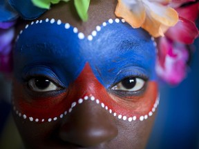 A carnival reveler poses for a picture before the start of a carnival parade in Port-au-Prince, Haiti, Monday, Feb. 12, 2018.