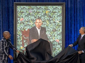 Former President Barack Obama, right, and Artist Kehinde Wiley, left, unveil Obama's official portrait at the Smithsonian's National Portrait Gallery, Monday, Feb. 12, 2018, in Washington.