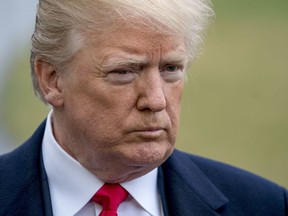 President Donald Trump takes a question from reporters before boarding Marine One on the South Lawn of the White House in Washington, Friday, Feb. 23, 2018, to travel to Oxon Hill, Md. to speak at the Conservative Political Action Conference (CPAC).