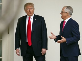 President Donald Trump and Australian Prime Minister Malcolm Turnbull talk as they walk along the colonnade to the Oval Office of the White House in Washington, Friday, Feb. 23, 2018.