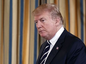 President Donald Trump arrives to hosts a listening session with high school students, teachers, and others in the State Dining Room of the White House in Washington, Wednesday, Feb. 21, 2018.