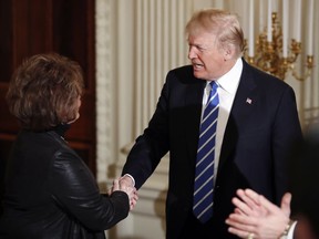 President Donald Trump shakes hands with Iowa House Speaker Linda Upmeyer, as he arrives in the State Dining Room of the White House in Washington, Monday, Feb. 12, 2018, during a meeting with state and local officials about infrastructure.