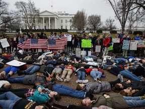 Demonstrators participate in a "lie-in" during a protest in favor of gun control reform in front of the White House, Monday, Feb. 19, 2018, in Washington.