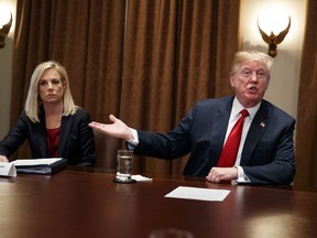 Secretary of Homeland Security Kirstjen Nielsen listens as President Donald Trump speaks during a meeting with law enforcement officials on the MS-13 street gang and border security, in the Cabinet Room of the White House, Tuesday, Feb. 6, 2018, in Washington.