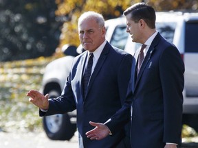 In this Nov. 29, 2017 file photo, White House Chief of Staff John Kelly, left, walks with White House staff secretary Rob Porter to board Marine One on the South Lawn of the White House in Washington.