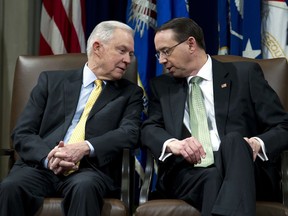 Attorney General Jeff Sessions speaks with Deputy Attorney General Rod Rosenstein, during the opening of the summit on Efforts to Combat Human Trafficking at Department of Justice in Washington, Friday, Feb. 2, 2018.