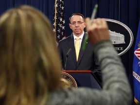 A reporter raises her hands to ask a question of Deputy Attorney General Rod Rosenstein, after he announced that the office of special counsel Robert Mueller says a grand jury has charged 13 Russian nationals and several Russian entities, Friday, Feb. 16, 2018, in Washington. The defendants are accused of violating U.S. criminal laws to interfere with American elections and the political process.
