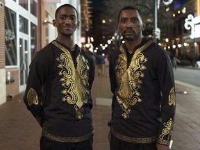 Khalel Robinson, left, poses with his father Jossan Robinson before seeing Black Panther in Silver Spring, Md., Thursday, Feb. 15, 2018.