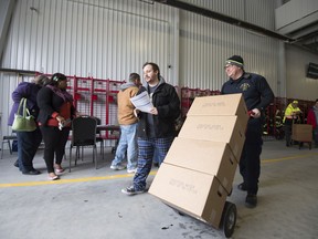 Residents wait in line to receive water at the Blades Volunteer Fire Company, Friday, Feb. 9, 2018, in Blades. Del. State environmental and public health officials announced late Thursday that sampling done at the request of the Environmental Protection Agency found that all three of the town of Blade's drinking water wells had high concentrations of perfluorinated compounds.