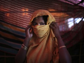 FILE- In this Thursday, Nov. 23, 2017, file photo, S, 22, mother of one, who says she was raped by members of Myanmar's armed forces in late August, is photographed in her tent in Gundum refugee camp in Bangladesh. Three female Nobel Peace Laureates are beginning a weeklong trip to Bangladesh to meet Rohingya women who have been tortured, raped and even killed by Myanmar soldiers amid a delayed repatriation process.