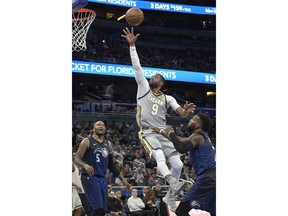 Cleveland Cavaliers guard Dwyane Wade (9) puts up a shot between Orlando Magic forward Marreese Speights (5) and guard Shelvin Mack (7) during the first half of NBA basketball game Tuesday, Feb. 6, 2018, in Orlando, Fla.