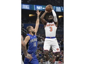 New York Knicks forward Tim Hardaway Jr. (3) goes up for a shot in front of Orlando Magic forward Evan Fournier (10) during the first half of an NBA basketball game Thursday, Feb. 22, 2018, in Orlando, Fla.