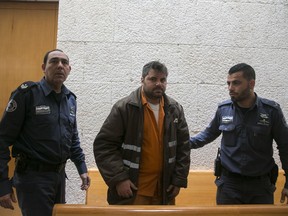 Yosef Haim Ben David is brought to a court in Jerusalem Thursday, Feb. 8, 2018. Israel's Supreme Court has rejected appeals filed by Ben David and two underage accomplices who were convicted in 2016 of abducting 16-year-old Mohammed Abu Khdeir and burning him to death.