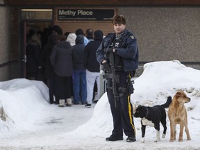 Police stand guard outside court as a provincial court judge decides if a teen who pleaded guilty in the 2016 shooting spree that left four people dead and seven others wounded will be sentenced as an adult in La Loche, Sask. on Friday February 23, 2018.