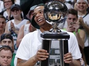 Michigan State's Miles Bridges carries the Big Ten regular-season championship trophy following the team's 81-61 win over Illinois in an NCAA college basketball game, Tuesday, Feb. 20, 2018, in East Lansing, Mich. Michigan State sealed at least a tie for the season title.