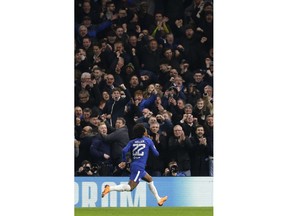 Chelsea's Willian celebrates scoring the opening goal during a Champions League round of sixteen first leg soccer match between FC Barcelona and Chelsea at Stamford Bridge stadium in London, Tuesday, Feb. 20, 2018.