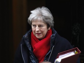 Britain's Prime Minister Theresa May leaves 10 Downing Street to attend the weekly Prime Ministers' Questions session, in parliament in London, Wednesday, Feb. 21, 2018.