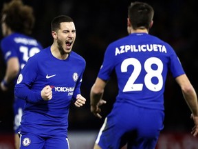 Chelsea's Eden Hazard, left, celebrates with teammate Cesar Azpilicueta after scoring his side's first goal during the English Premier League soccer match between Watford and Chelsea at Vicarage Road stadium in London, Monday, Feb. 5, 2018.