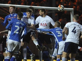 Rochdale's Mark Kitching, second from right, heads the ball during the English FA Cup fifth round soccer match between Rochdale AFC and Tottenham Hotspur at the Crown Oil Arena in Rochdale, England, Sunday, Feb. 18, 2018.